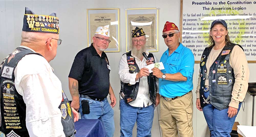 Mark Meysembourg is shown presenting donations totaling over $19,000 collected during fundraisers this past year to National Commander James “Bill” Oxford from the Department of Virginia. Donations from Texas alone totaled approximately $35,000. Also pictured to the left of Mark is the Department of Texas Commander Bret Watson. On the right is the National Auxiliary President, Nicole Clapp from the Department of Iowa.  Looking on is National American Legion Riders Chairman Mark Clark from the Department of Missouri. 