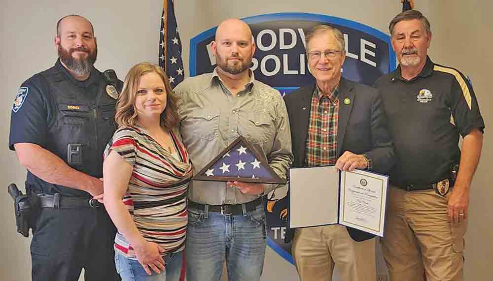 Woodville police officer Troy Costello (center) was presented with an American flag and commendation by U.S. Rep Brian Babin (second from right). Shown with Costello and Babin are, left-to-right: Capt. Jathan Borel with the Woodville PD; Delynda Costello and Woodville Chief of Police Mike McCulley.  PHOTO COURTESY OF REP. BRIAN BABIN