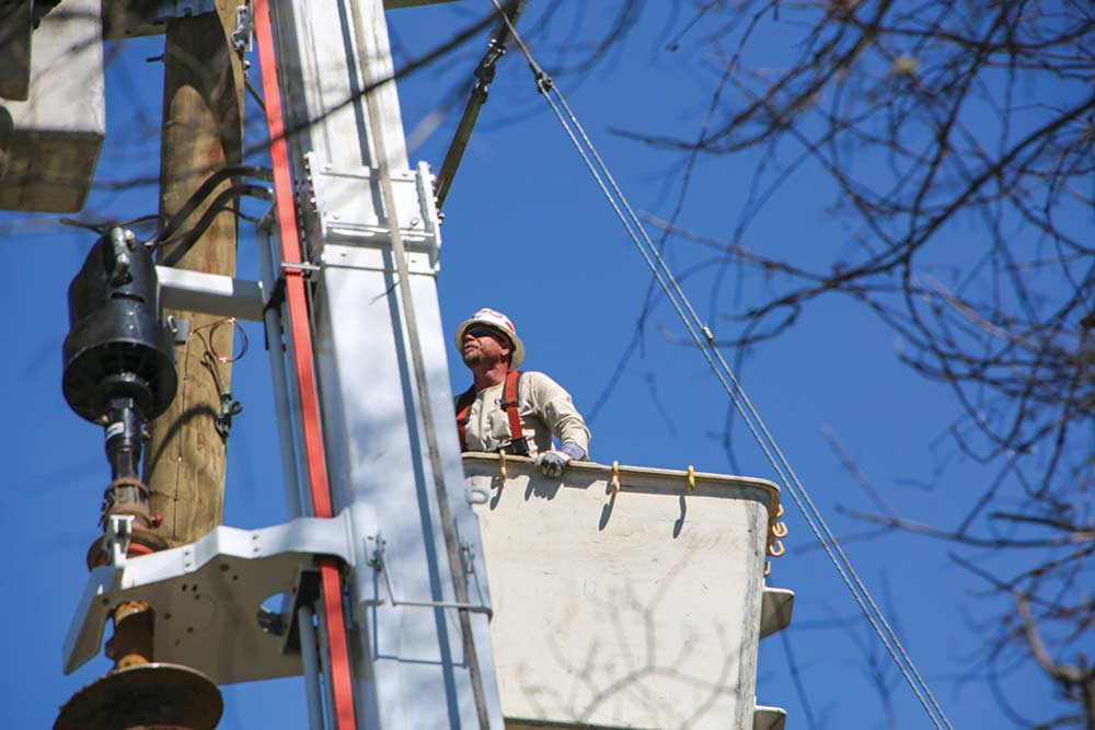 An HCEC worker repairs a connection last week in the tornado’s aftermath. Photo courtesy of HCEC 