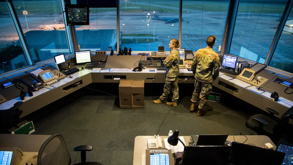 Staff Sgt. Jordan L. McFarland (left), 2nd Operations Support Squadron air traffic control craftsman, and Senior Airman Hunter J. Maggard, 2nd OSS air traffic control apprentice (right), keep an eye out for an aircraft that is scheduled to land at Barksdale Air Force Base, Louisiana, August 22, 2019. While working eight hour shifts in a small tower, the 2nd OSS air traffic controllers are able to spend a lot of time getting to better know their wingmen. (U.S. Air Force photo by Airman Jacob B. Wrightsman)