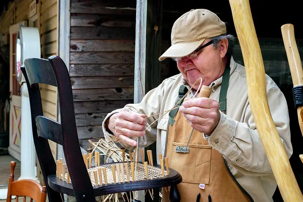 In this file photo from the 2018 Festival of the Arts, a chair caner practices his artform. This, along with blacksmithing and spinning and weaving, are among the many demonstrations festivalgoers can take in this weekend. JIM POWERS | TCB 