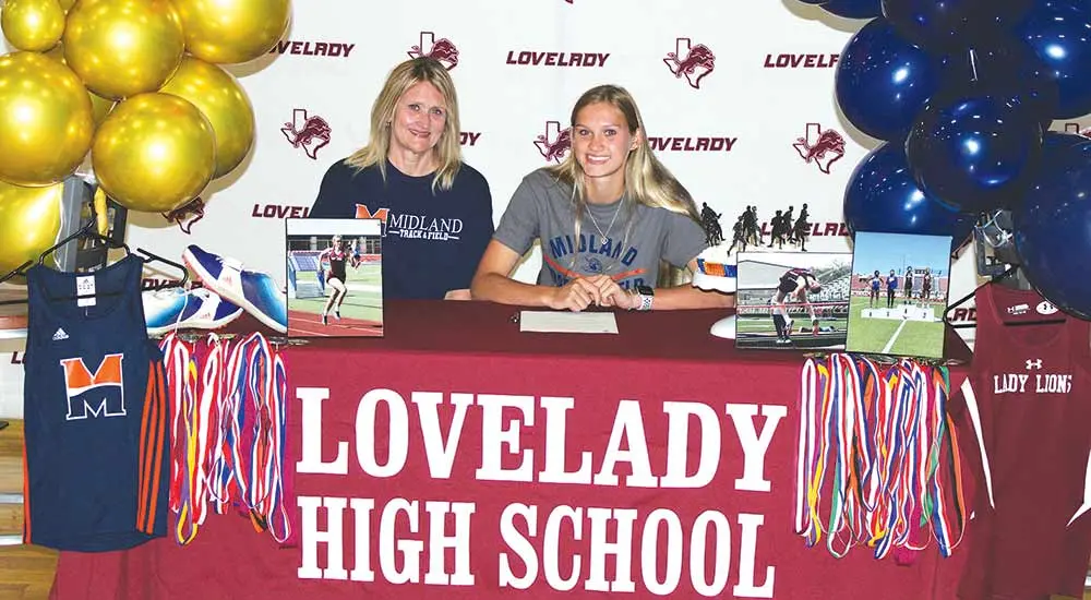 Shyanne Pipkin, pictured with mother Beth Pipkin, signs a letter of intent with Midland University (Nebraska) during a ceremony Tuesday, May 17. A bevy of track and field medals that Pipkin earned during her high school career are draped over the signing table.  LARRY LAMB | HCC