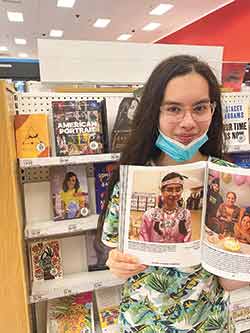 Aaliyah Johnson, 14, an incoming ninth-grader at Big Sandy High School, shows off her picture in the newly released PBS book “American Portrait: The Story of Us, Told by Us.” Both Aaliyah and her mother submitted entries that were included in the book. Courtesy photo