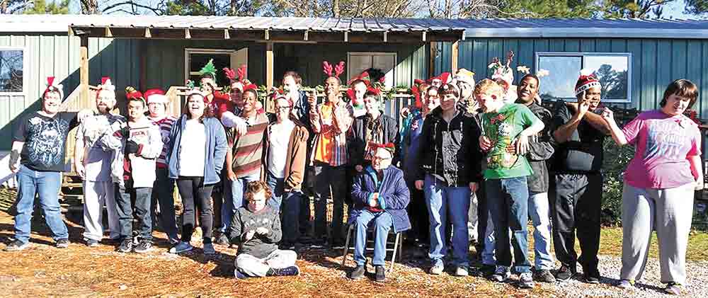 The staff and clients of Inspiration Village, a ranch for mentally challenged adolescents and adults. The camp will close its operation Feb. 24.  Courtesy photo