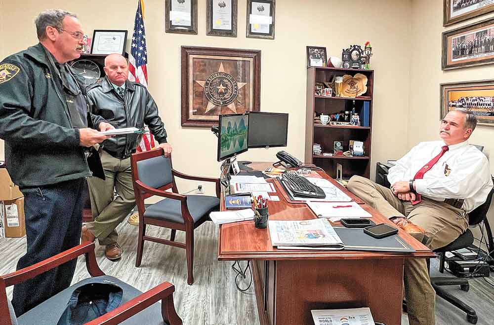 San Jacinto County Chief Deputy Tim Kean, Commander Lt. Ray Bowen and Sheriff Greg Capers discuss plans for a community policing effort in the county. Courtesy photo