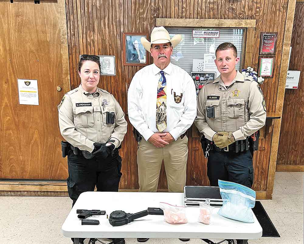 Deputy Sheriff Samantha Crenshaw, Sheriff Greg Capers and Sgt. Rodney Nash display the seized items the SO gathered following a traffic stop in Shepherd. Courtesy photo