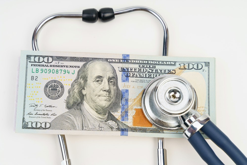 Business and medicine concept. There is a stethoscope on the dollars.