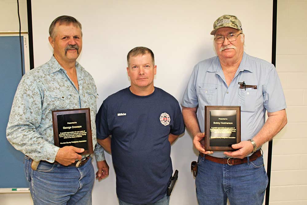 Former Houston County Emergency Services District No. 2 President George Crowson, left, and Vice President Bobby Hutcherson, right, were recognized and presented plaques in grateful appreciation for their many years of dedicated service and personal commitment to the district and county fire departments by Houston County Firefighters Association President Michael Sessions, center, and other association members.