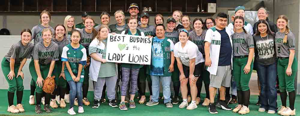 The Livingston Best Buddies participated in last week’s Lady Lion softball game. (Left) Catcher Baylee Yantes walks her new buddy out onto the field. Courtesy photo