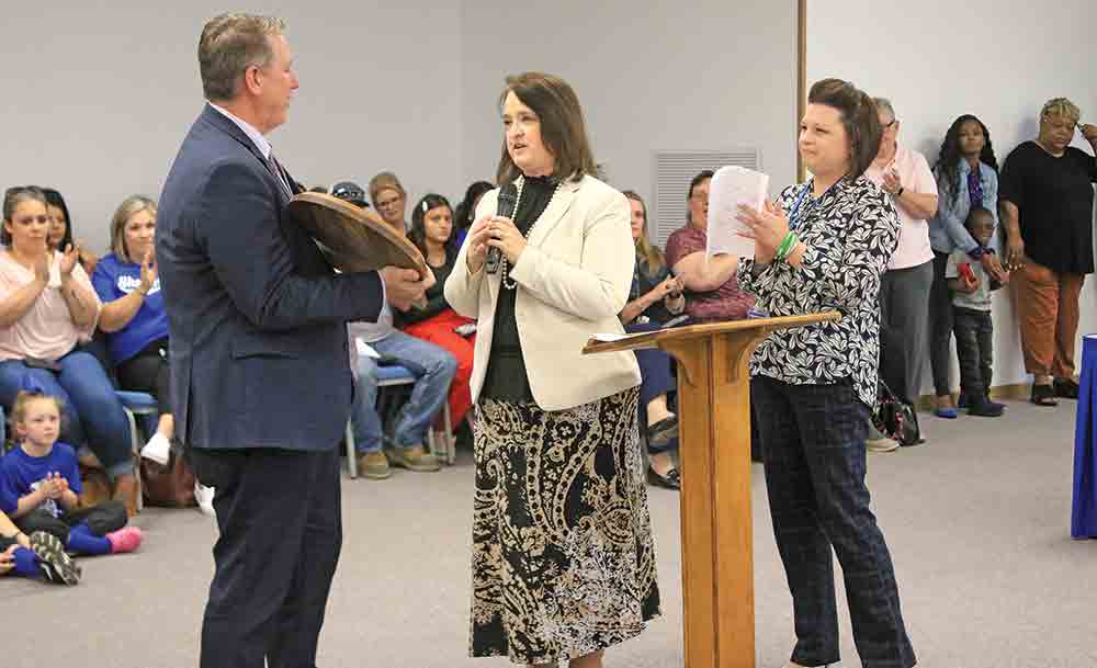 Shepherd ISD Superintendent Jason Hewitt (left) was honored by Board of Managers President Yvonne Johnson and Assistant Superintendent DeAnna Clavell for bringing up the school’s overall grade to a B from an F. Photo by Tony Farkas