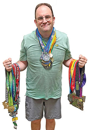 Brad Butler with medals from all 50 states.