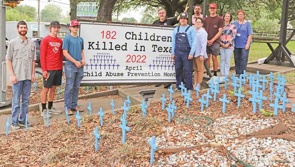 Members of the Tyler County Child Welfare Board are shown with students from the Colmesneil High School Buildings and Trade class and CHS principal Stephanie Smith. The students installed blue crosses in front of the Tyler County Courthouse, at the corner of US 190 and 69. The crosses are a sobering reminder and tribute to the 182 children who died, statewide, last year due to abuse and/or neglect. April is celebrated as Child Abuse Prevention Month.  CHRIS EDWARDS | TCB
