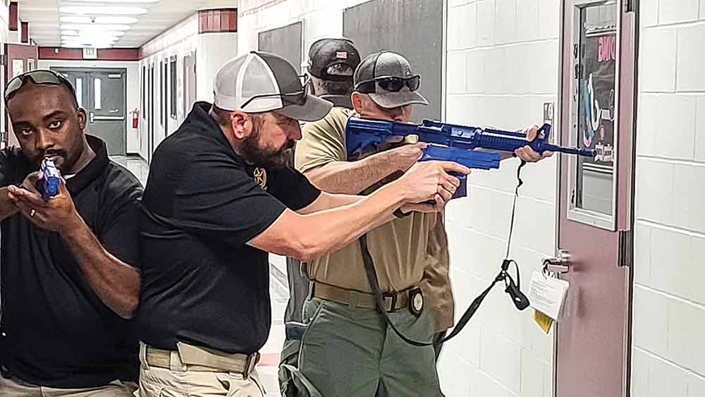 Law enforcement officers demonstrate procedures to be taken in the event of an active shooter situation during training at COCISD campuses in July. Photo by Cassie Gregory