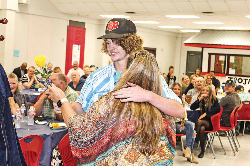 COHS senior Hayden Ferguson hugged his mom, Stacey, as he presented her with a rose after hanging up his FFA jacket for the last time at the 2022 Coldspring FFA Banquet. Mary Trimmer Photo