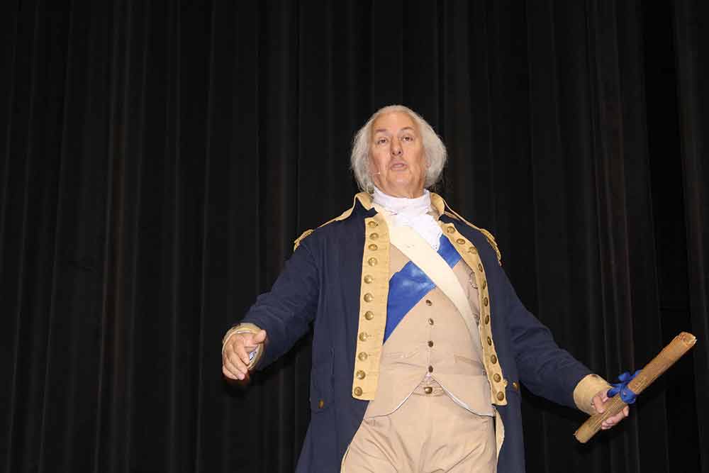 Mark Collins, playing the part of George Washington, spoke to attendees at Friday’s conference. (ALTON PORTER | HCC)