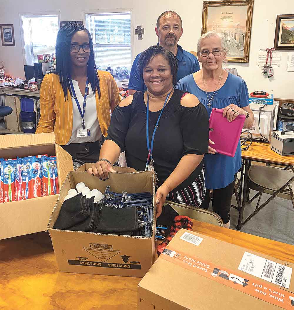 Employees of the IAH Secure Adult Detention Facility recently increased awareness of homelessness by making 75 care packages to deliver to Godtel Ministries and Our Father’s House. (l-r) Patrecia Escobedo, the warden’s secretary; Dendra Butler, HR assistant; Michael Dickens, chief of security; and a representative from Godtel Ministries.