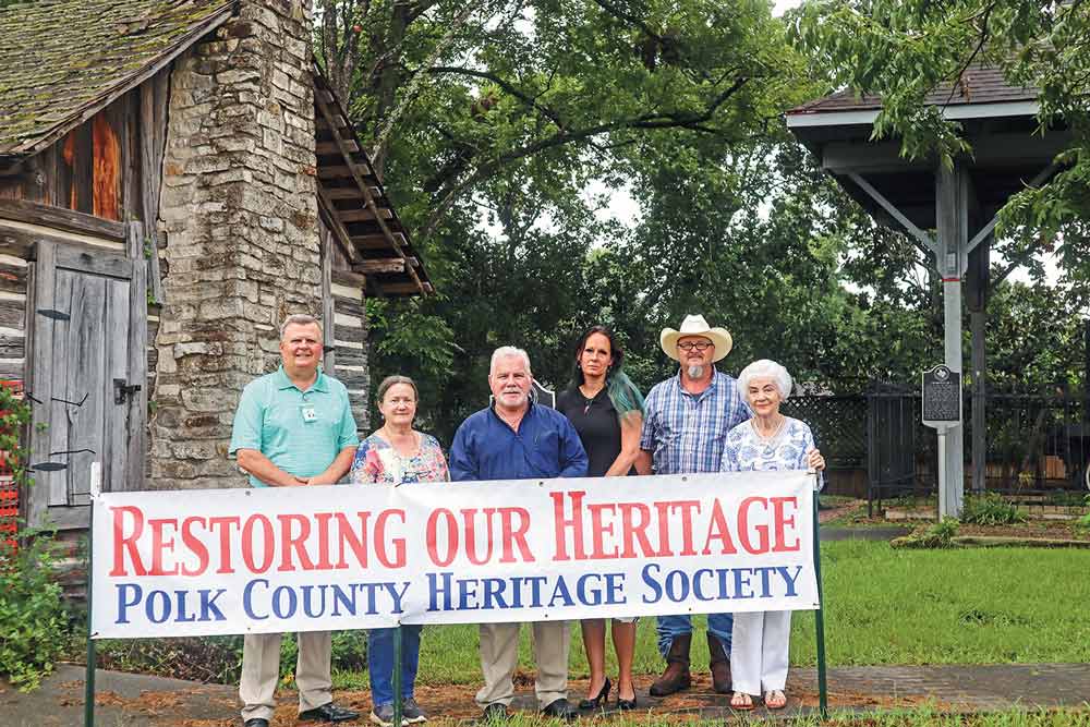 RESTORING OUR HERITAGE The Jonas Davis Log Cabin in Heritage Park is the beneficiary of a $35,000 gift from The Smith Family Foundation given to the Polk County Heritage Society to repair and refurbish the roof of the cabin which has been taken over by resurrection fern. (l-r) Livingston City Manager Bill S. Wiggins; Heritage Society Member Molly Anderson; Robert Smith, representing The Smith Family Foundation; Samantha Legg, Smith’s personal assistant; Heritage Society Member Patrick Swilley; and Heritage Society Member Ruth Hollenbeck. Not pictured: Fred M. Smith, representing The Smith Family Foundation. Photo by Emily Banks Wooten 
