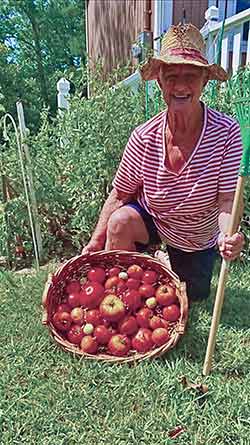 Judy Connelly enjoys a day working in her garden. (PHOTO BY EMILY EDDINS)