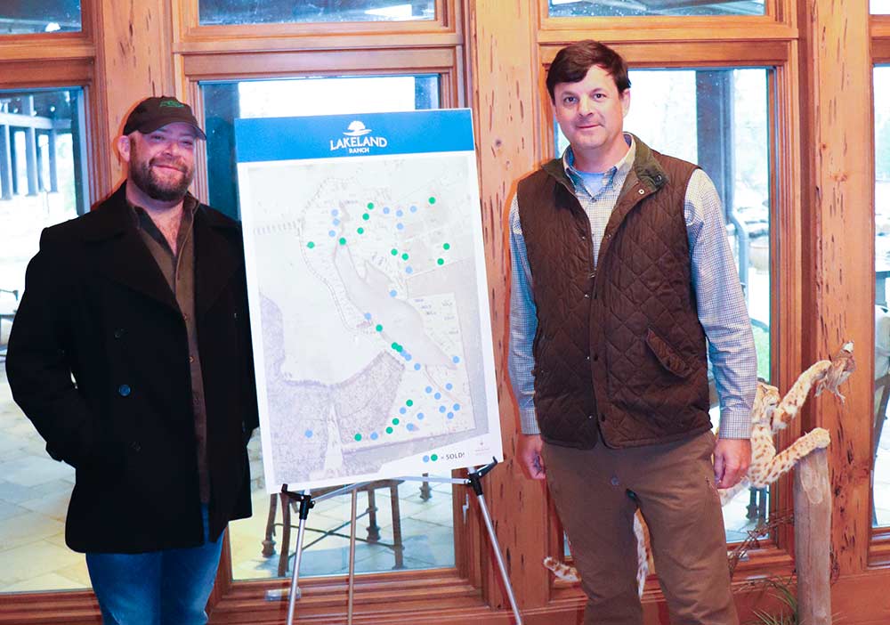 Lakeland developer Gates Walcott (left) and Gene Stock, a business partner, stand in front of a map outlining the Lakeland Ranch subdivision. CHRIS EDWARDS | TCB 