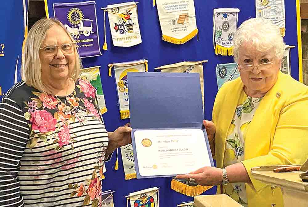 Rotarian Judy Cochran presents a Paul Harris Fellowship Award to Marilyn Wise. Photo by Ann McDonald
