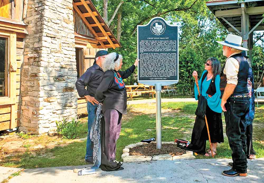 Descendants of Chief John Blount and their spouses admire the historic marker honoring him that was unveiled and dedicated Sunday at Heritage Park in Livingston. Blount was chief of the Apalachicola Band of Creek Indians that settled in Polk County in 1834. One of Blount’s sixth generation descendants was inaugurated as new chief of the tribe during a ceremony Sunday. (l-r) Eugene LeBeaux, Gleni Tai Blount, Chief Cynthia Healing Woman Tune Murphey and Michael Martin Murphey. Photo by Emily Banks Wooten