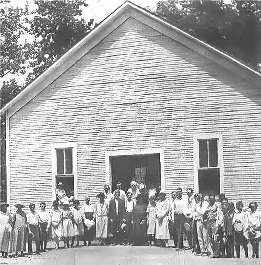  A group of churchgoers in front of what was the original First Baptist Church Building which was located on FM 1988 West across the railroad tracks. Courtesy photo