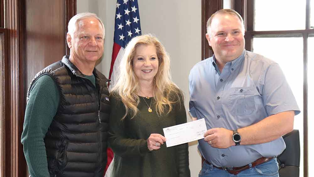 Russ and Nancy Pilgrim of Pilgrim Insurance Agency present a donation of $950 to Pct. 1 Commissioner Joe Blacksher for the county’s senior nutrition program.  CHRIS EDWARDS | TCB