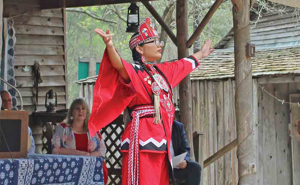 Princess Aionna Morena of the Alabama-Coushatta tribe performs the Lord’s Prayer for the crowd at the Heritage Village Texas Independence Day celebration last Thursday. Mollie La Salle | TCB