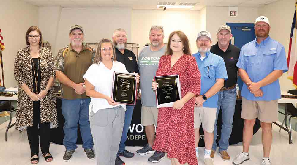 At its monthly meeting, the Woodville ISD Board of Trustees recognized district retirees Pam Minyard and Teresa Bryant (pictured in front). Pictured behind them (left-to-right) are: WISD superintendent Lisa Meysembourg; WISD trustees John David Risinger; Jimmy Tucker; John Wilson; Bryan Shirley; Richard “Kooter” Shaw and Kris Fowler.  CHRIS EDWARDS | TCB