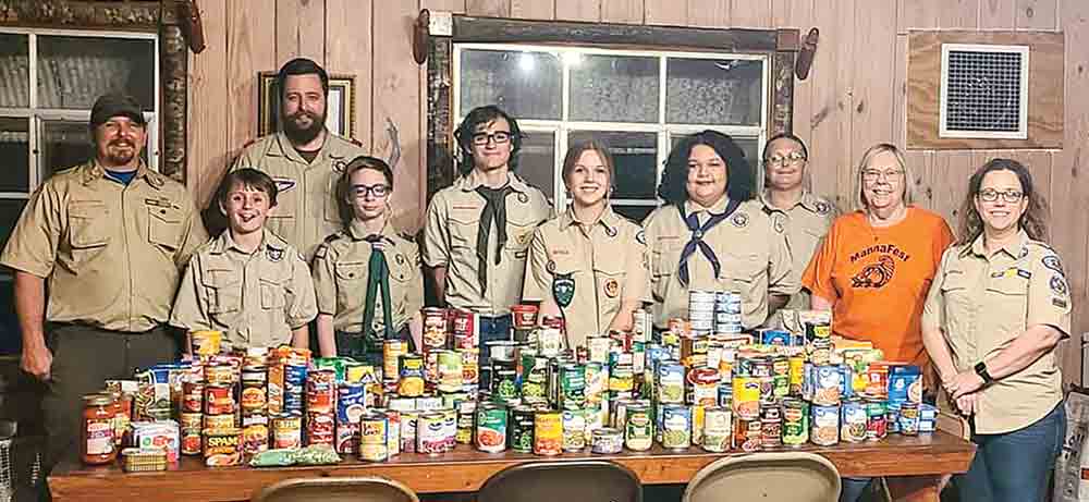 Boy Scout Troop 97 and Girl Scout Troop 197 held a food drive in March that they donated to MannaFest Food Pantry. (l-r) Troop 97 Scoutmaster David Brown, Evan Couch, Troop 97 Assistant Scoutmaster Adam Leneau, Silas Leneau, Samson Blackstock, Mary Jane Brown, Ally Agate, Troop 197 Scoutmaster Shawnna Agate, MannaFest Director Marilyn Wise and Trinity District Director Misty Brown. Courtesy photo