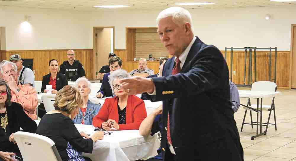 U.S. Rep. Pete Sessions points out members of his staff to the people assembled at a Feb. 14 town hall meeting. Photo by Tony Farkas