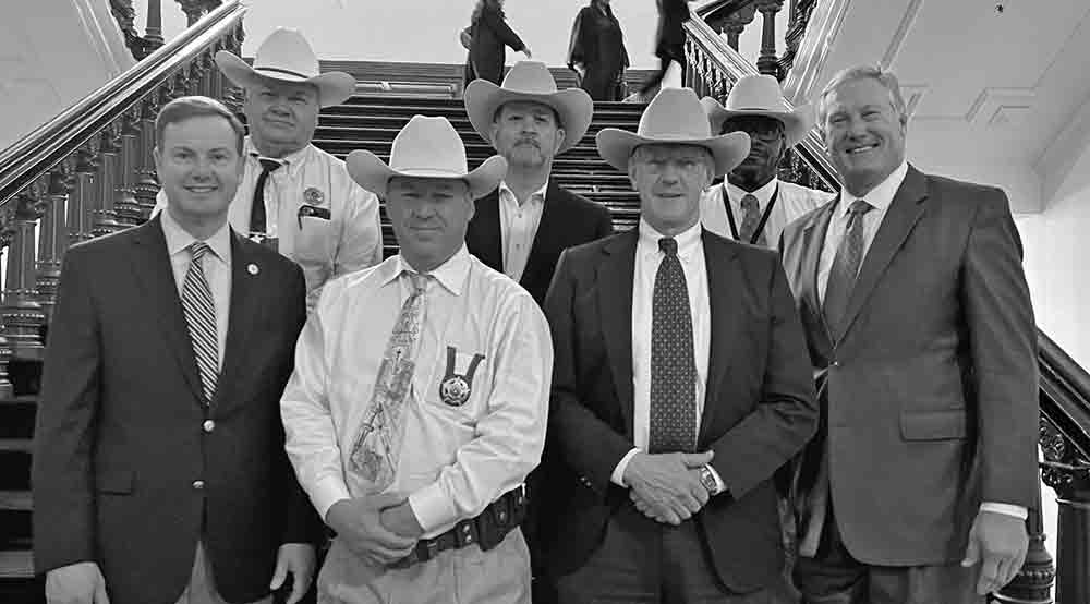 Photo right: Houston County Sheriff Randy Hargrove (back row, left) poses for a photo with several fellow county sheriffs and State Reps. Trent Ashby (R-Lufkin) (front row, left) and Travis Clardy (R-Nacogdoches), front row, far right. Courtesy photo