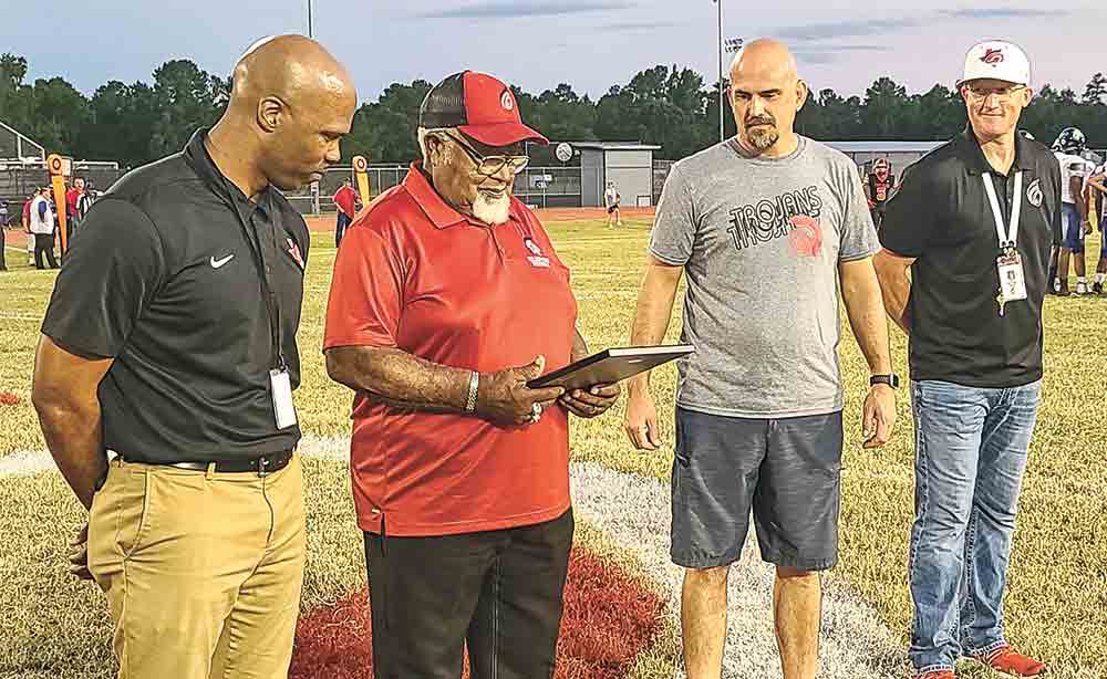 COCISD Board Trustee Berlin Bradford received a plaque to commemorate the naming of Trojan Field at Berlin Bradford Stadium in his honor. Bradford has served the COCISD  students and community for over 57 years, as a teacher, coach, and school board member. Photo by Cassie Gregory