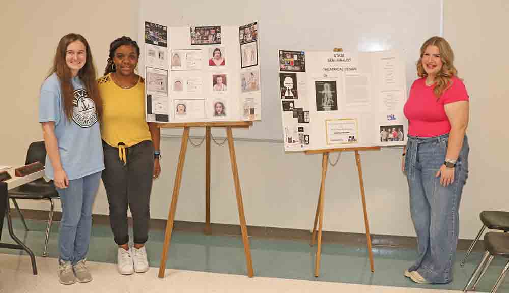 Theatre students A’Niyah Betts; Adrianna Stark and Lauren Gressler demonstrate their theatrical design project to the WISD Board of Trustees. The students, along with Kyson Hensarling (not pictured), under the direction of Melanie Spivey, placed within the top 12 in the entire state for the UIL Theatrical Design competition, and it was their first year to compete. CHRIS EDWARDS | TCB