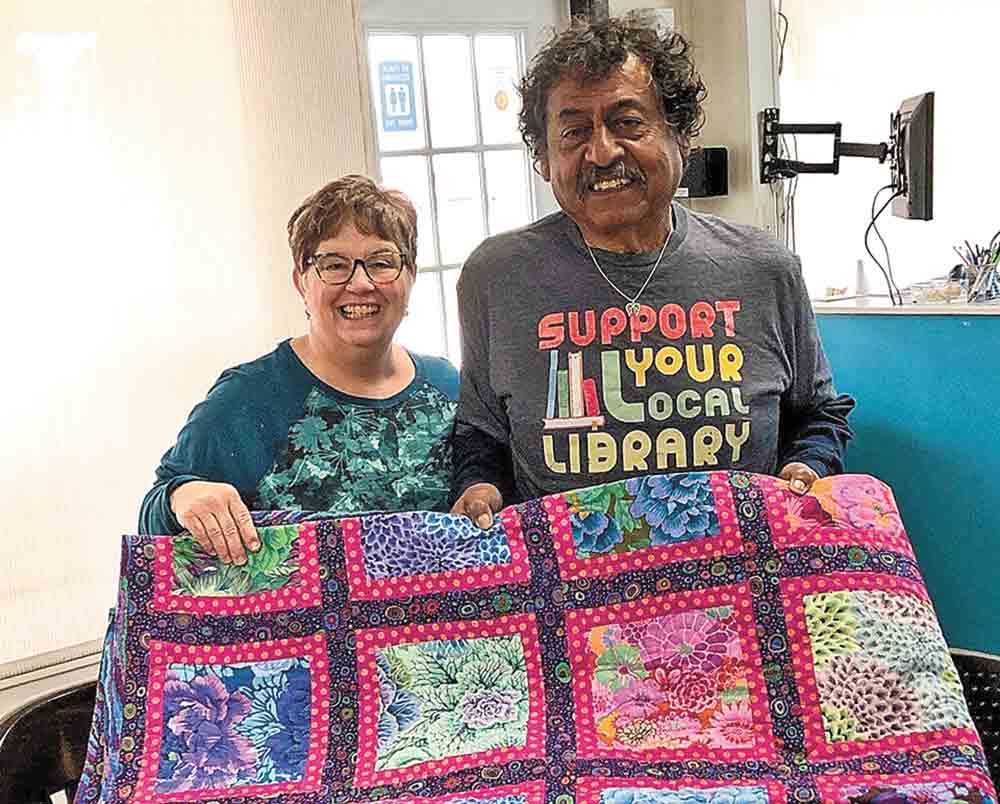 Winner of Shepherd library raffle first prize quilt was Rafael Gonzales, here with director Terri McIntyre.  Courtesy photos
