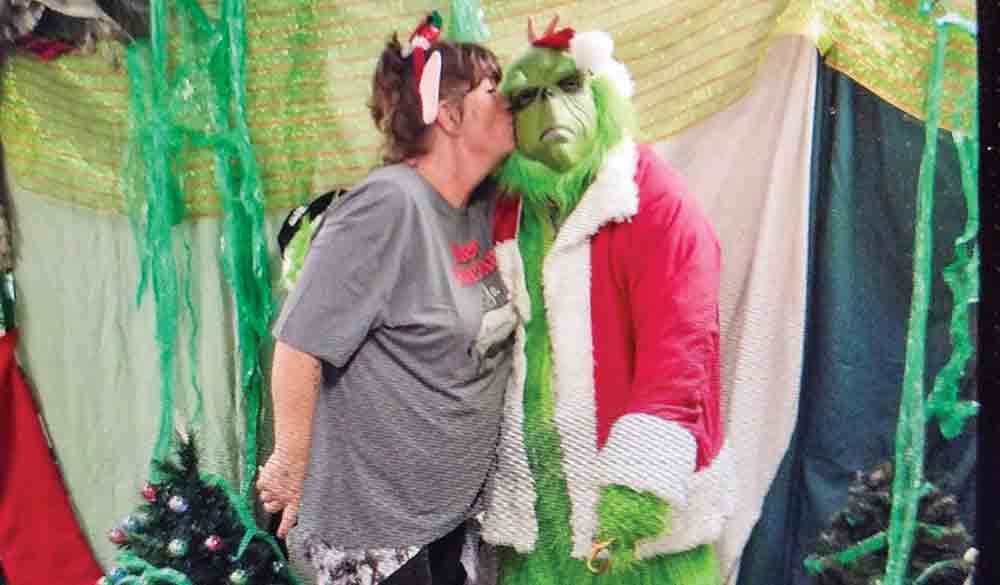 The Grinch gets a kiss, and his heart grew three sizes that day.