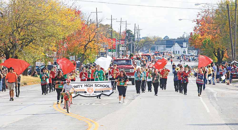 The Trinity High School Marching Band leads the way of the annual Christmas parade.