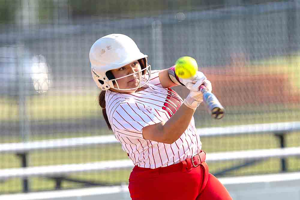 Haylee Rosales connects with a fastball for another hit during the Trinity-Coldspring game. See more photos on page 5B.  Photos by Charles Ballard
