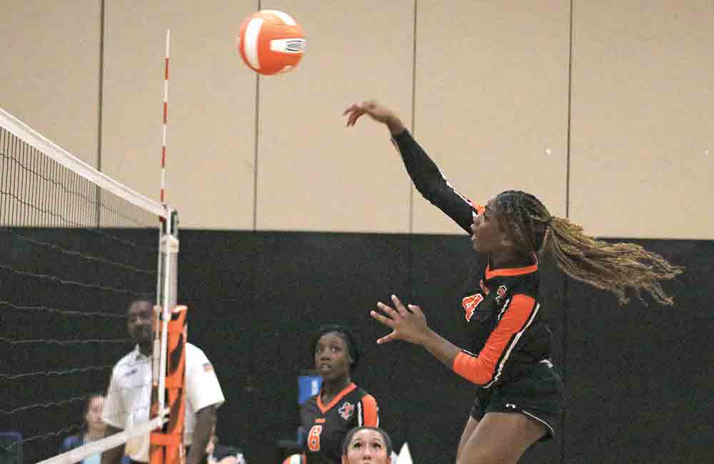 Lady Tiger Mariah Lewis (No. 4) goes up for the kill