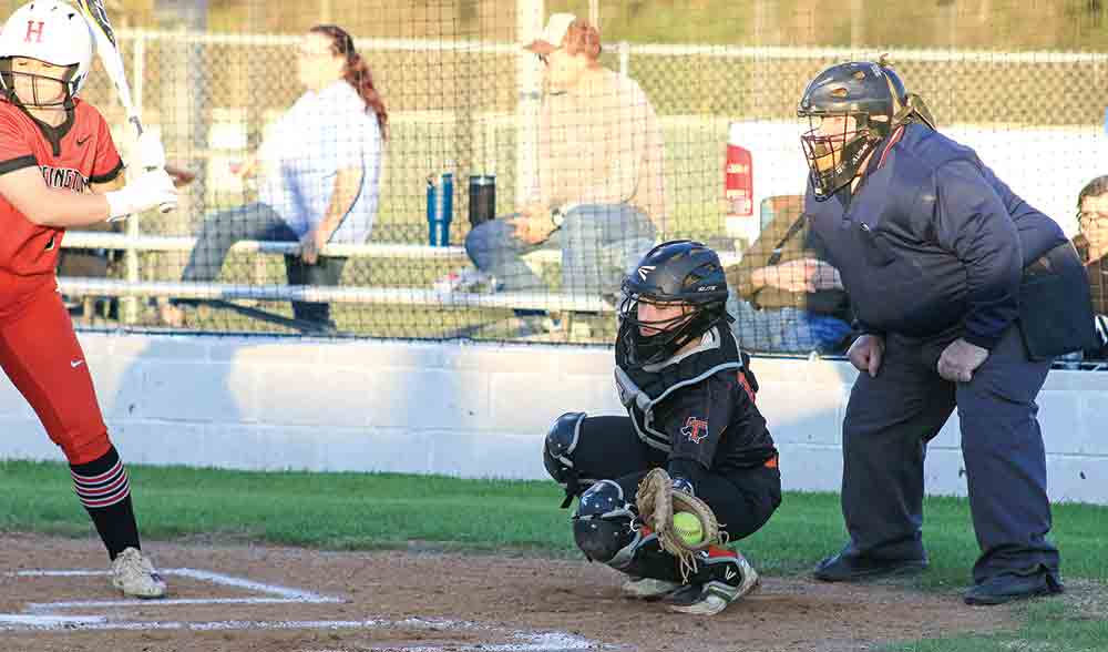 Trinity’s catcher L. Smith pulls in the wide pitch. Photos by Tony Farkas