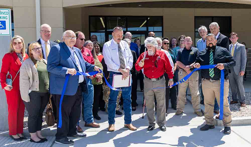 San Jacinto County Judge Fritz Faulkner and Commissioner David Brandon, as well as other county dignitaries, cut the ribbon on the county’s new Innovation Center.  Photo by Charles Ballard
