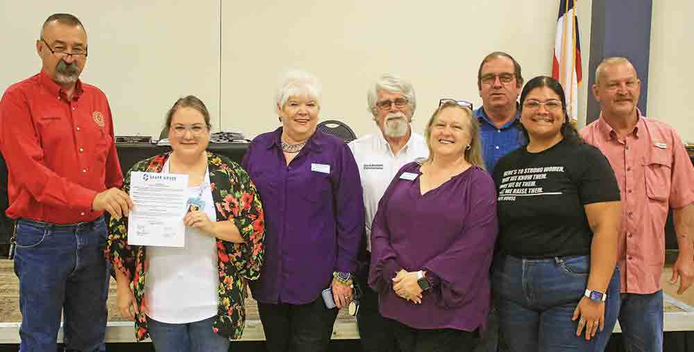 The San Jacinto County Commissioners Court, along with representatives from SAAFE House, display the proclamation naming October as Domestic Violence Awareness Month. Photo by Tony Farkas