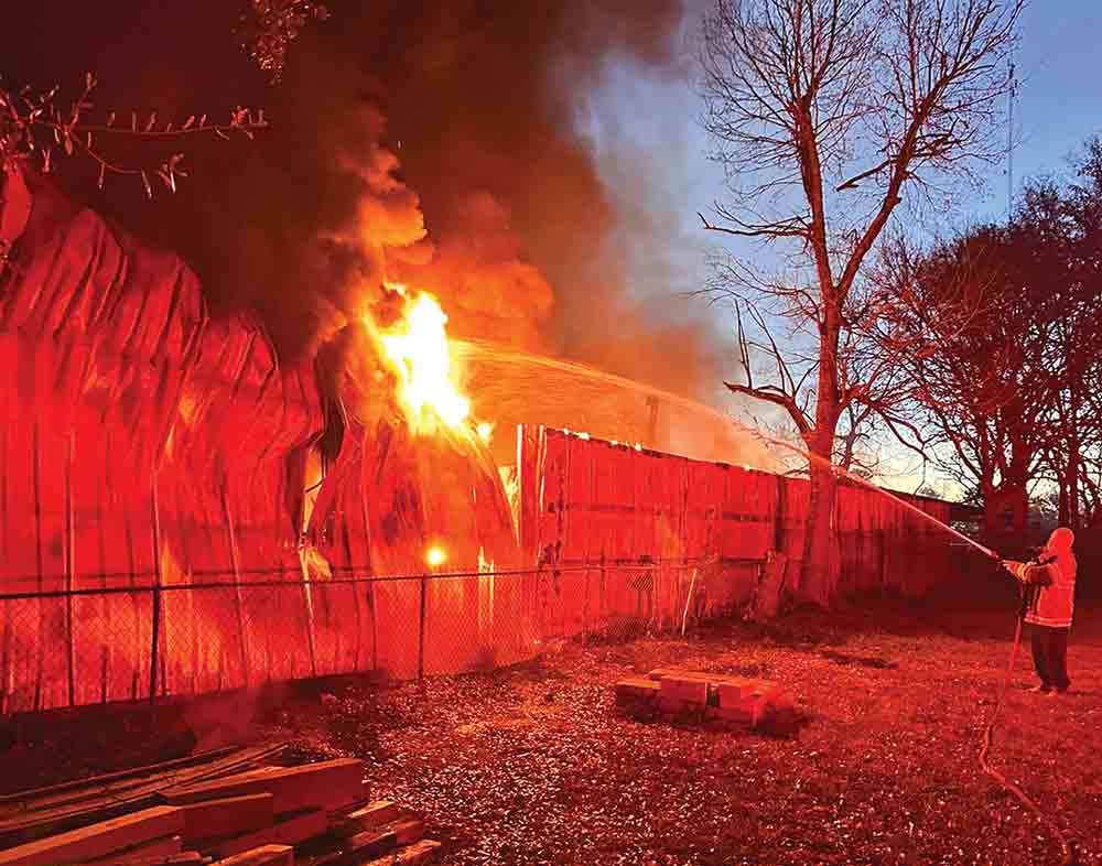 Groveton firefighters battle a blaze that broke out in a shop/barn in Groveton on Sunday morning. Courtesy photo