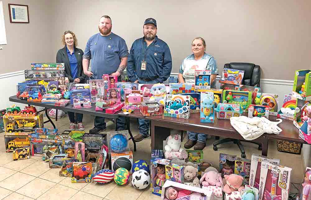 Georgia-Pacific employees show off some of the toys collected for area children in need. Helping with the project (L-R) are Carrie Speed, CASA Casework Supervisor; Georgia-Pacific employees Logan Gilbert, Lester Knight and Willa Roberts. Courtesy photo