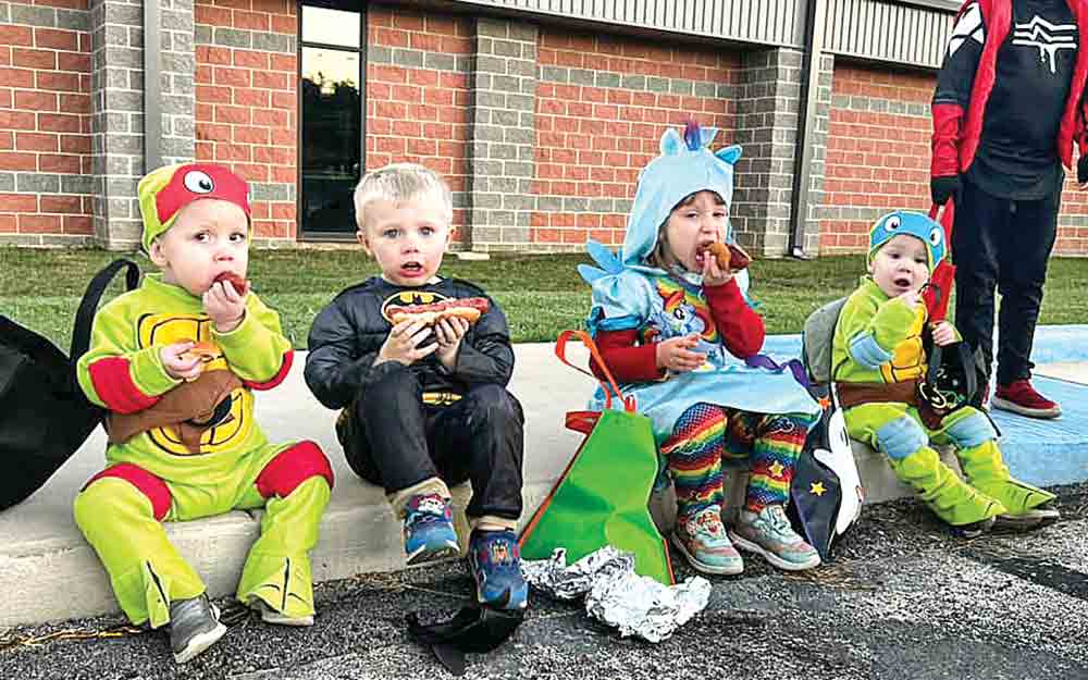 Batman, Rainbow Brite and a couple of the Teenage Mutant Ninja Turtles enjoy hot dogs at the COCISD Trunk ‘n’ Treat. (Below) Candy and treats were the order of the day at the COCISD Trunk ‘n’ Treat. Courtesy photo