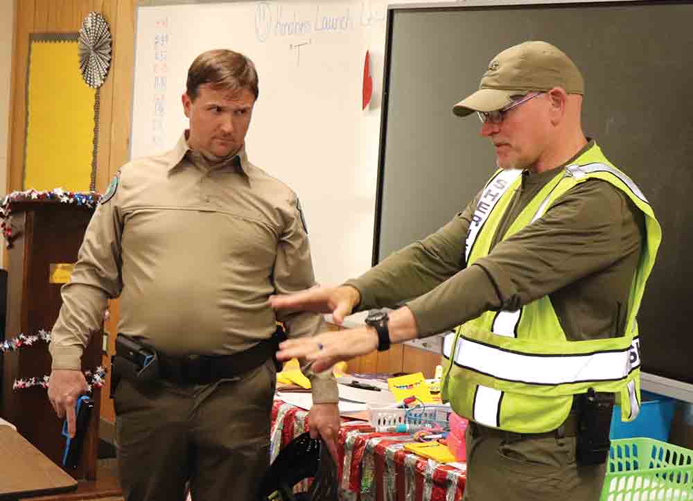 Game Warden Brandon Mosley and Jefferson County Sheriff’s Office Capt. James Riley discuss room entry protocol during the active shooter training at Woodville High School. CHRIS EDWARDS | TCB
