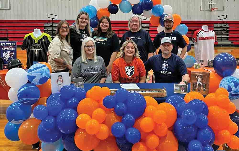Kaylee Harris (center) is flanked by family as she signs her letter of intent. COURTESY PHOTO
