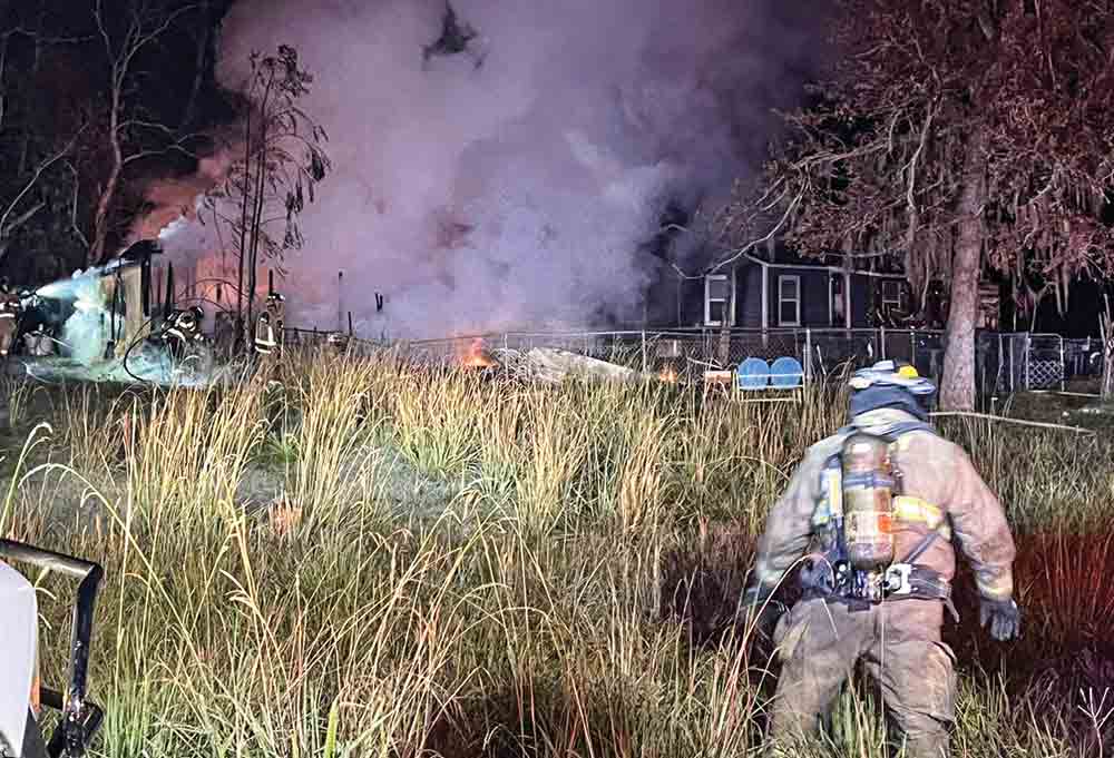 Firefighters from the 356 Volunteer Fire Department battle a blaze at a home on Armadillo Road near Trinity on Monday.  Courtesy photos  by Keith Johnson