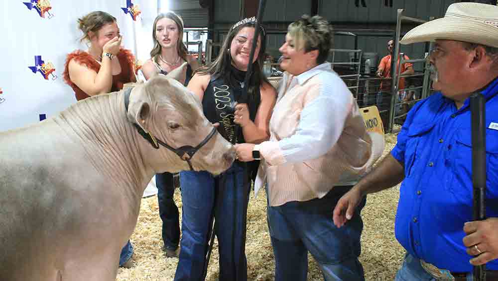 Grace Tullos shows her emotions after her Grand Champion steer sold for more than $10,000 at the Livestock Auction. Photos by Tony Farkas