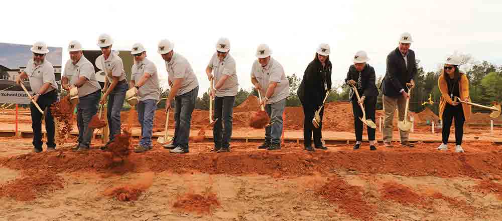 Members of the Woodville ISD Board of Trustees, Superintendent Lisa Meysembourg and members of the committee that promoted the WISD bond issue broke ground on Monday evening for the new Woodville Elementary campus. Pictured left-to-right: Jimmy Tucker; John Wilson; Josh McClure; Bryan Shirley; Kris Fowler; Richard “Kooter” Shaw; John David Risinger; Lisa Meysembourg; Eleanor Holderman; Trey Allison and Laura Conner. CHRIS EDWARDS | TCB
